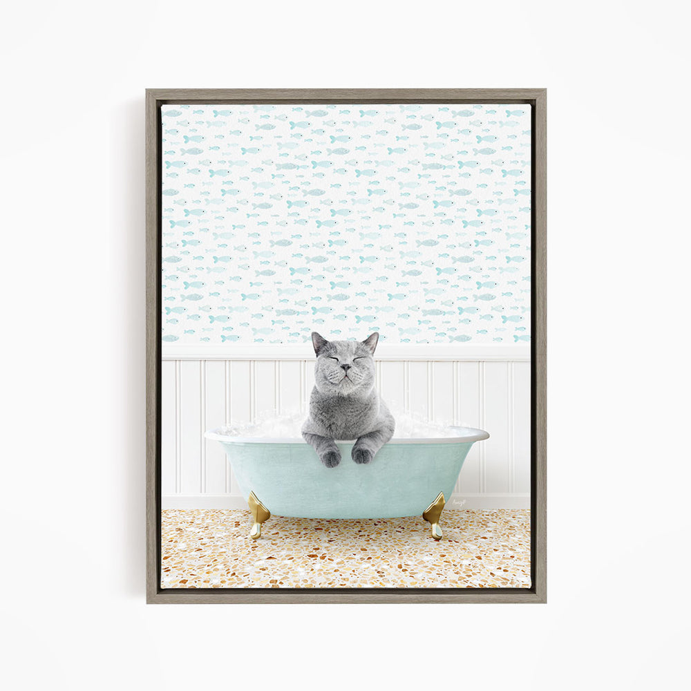 A gray cat sitting in a light blue bathtub, surrounded by a pattern of small fish.