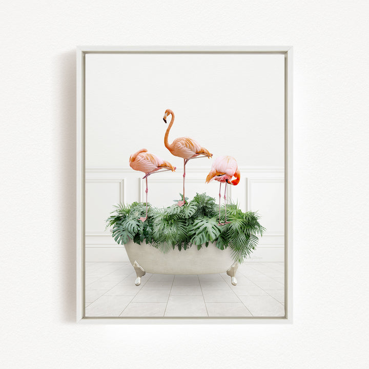 A framed image depicting three pink flamingos standing in a bathtub filled with green plants.