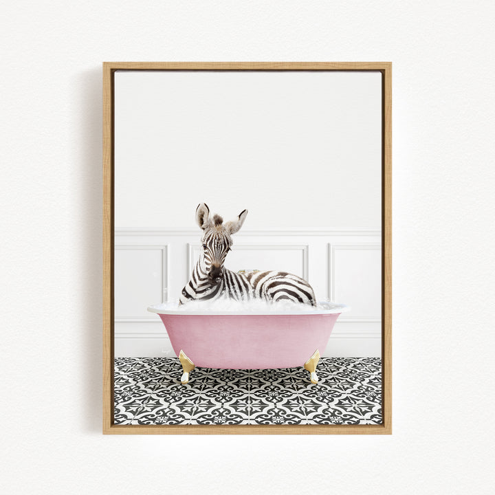 A zebra is sitting in a pink bathtub, surrounded by a black and white patterned floor.