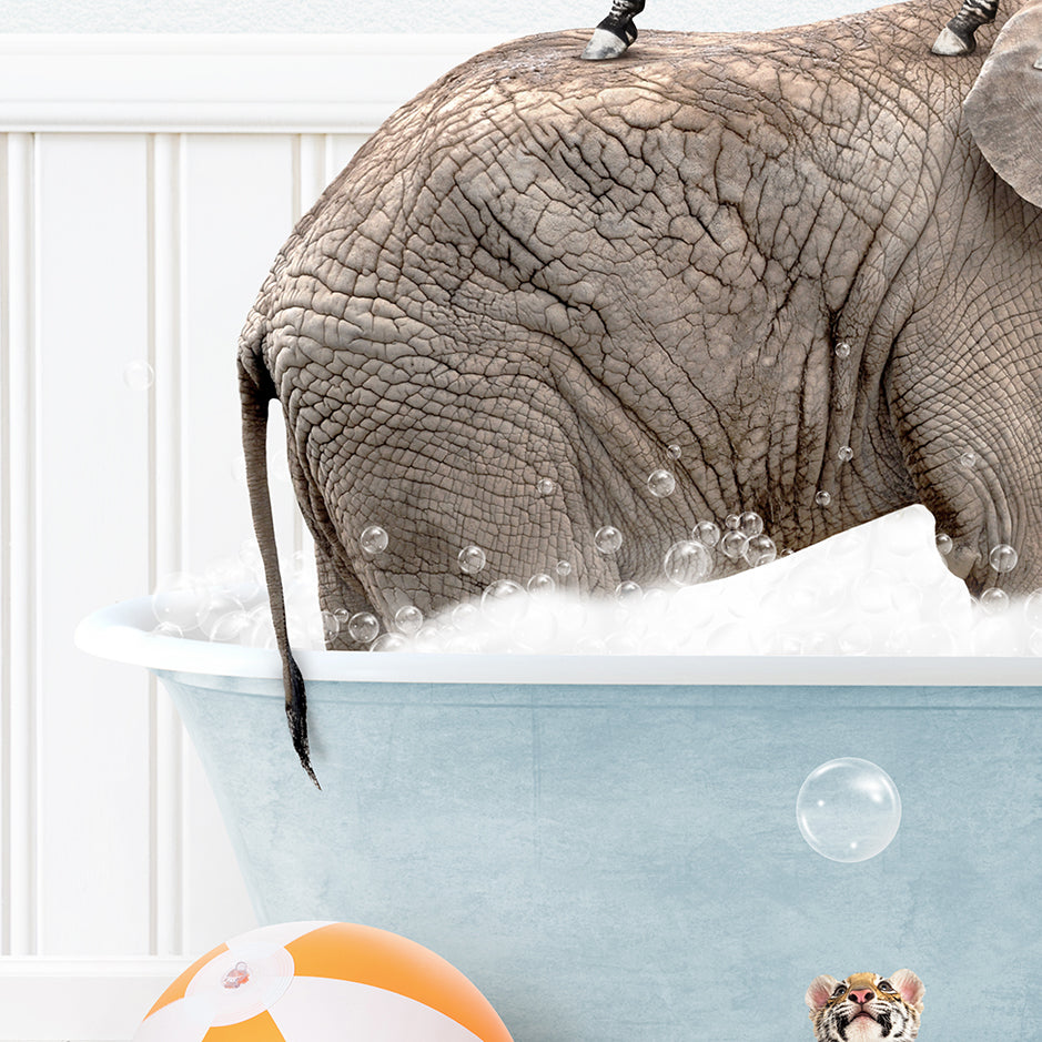 an elephant in a bathtub with bubbles and a ball