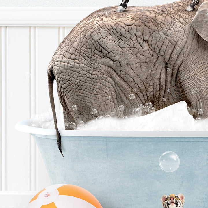 an elephant in a bathtub with bubbles and a ball