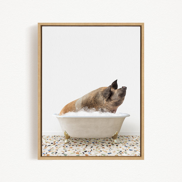 A brown pig sitting in a white bathtub filled with bubbles, looking up at the camera.