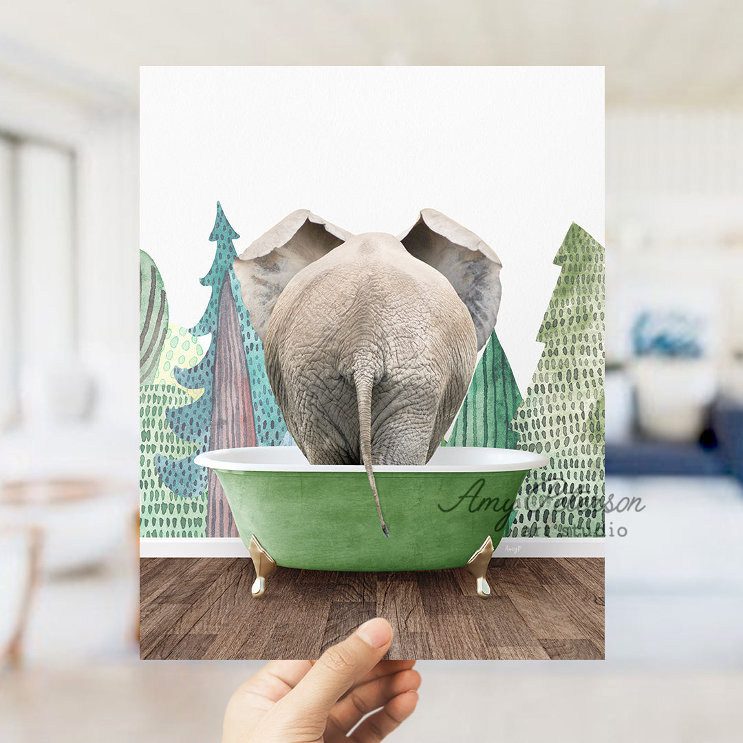 a person holding up a picture of an elephant in a bathtub