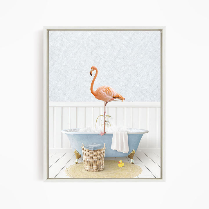 A pink flamingo stands on the edge of a blue clawfoot bathtub, surrounded by a yellow rubber duck, a woven basket, and a white towel.