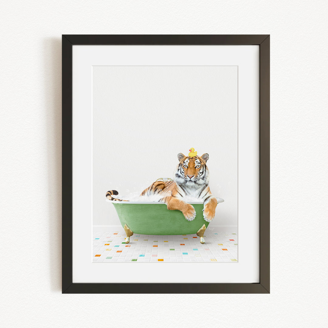 A tiger is sitting in a green bathtub, with a yellow rubber duck perched on its head.