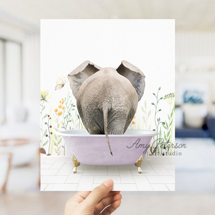 a person holding up a card with an elephant in a bathtub