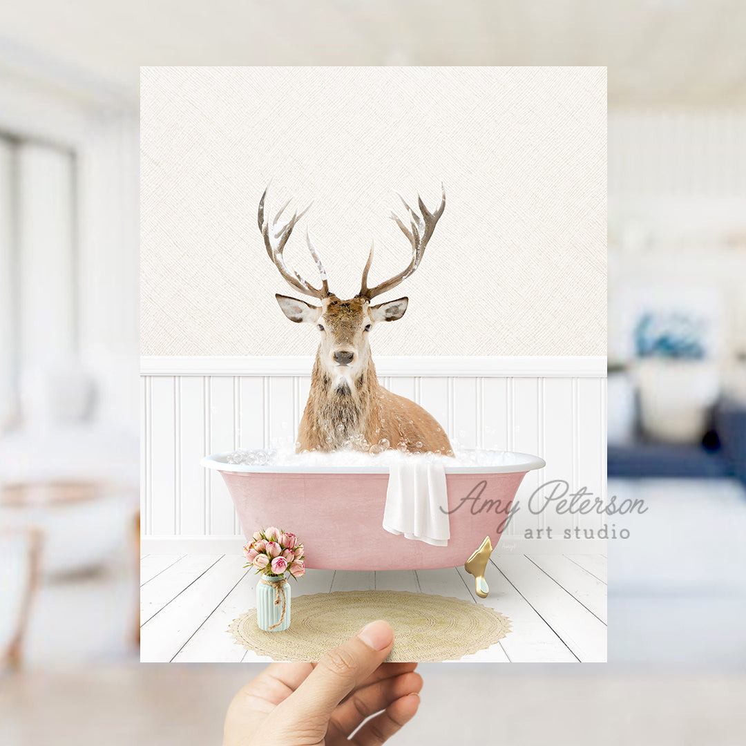 a hand holding up a card with a picture of a deer in a bathtub