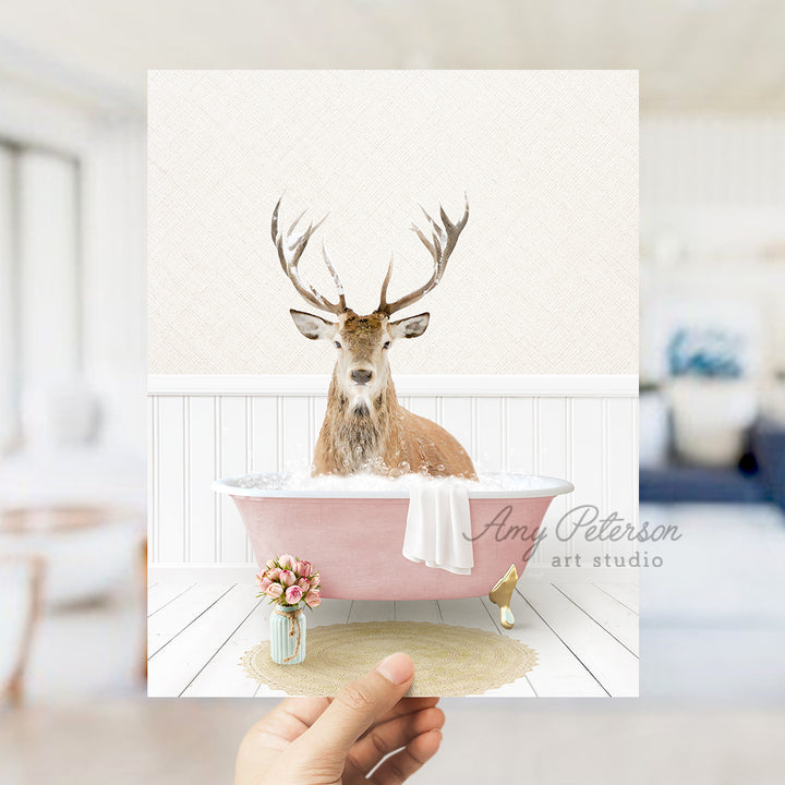 a hand holding up a card with a picture of a deer in a bathtub