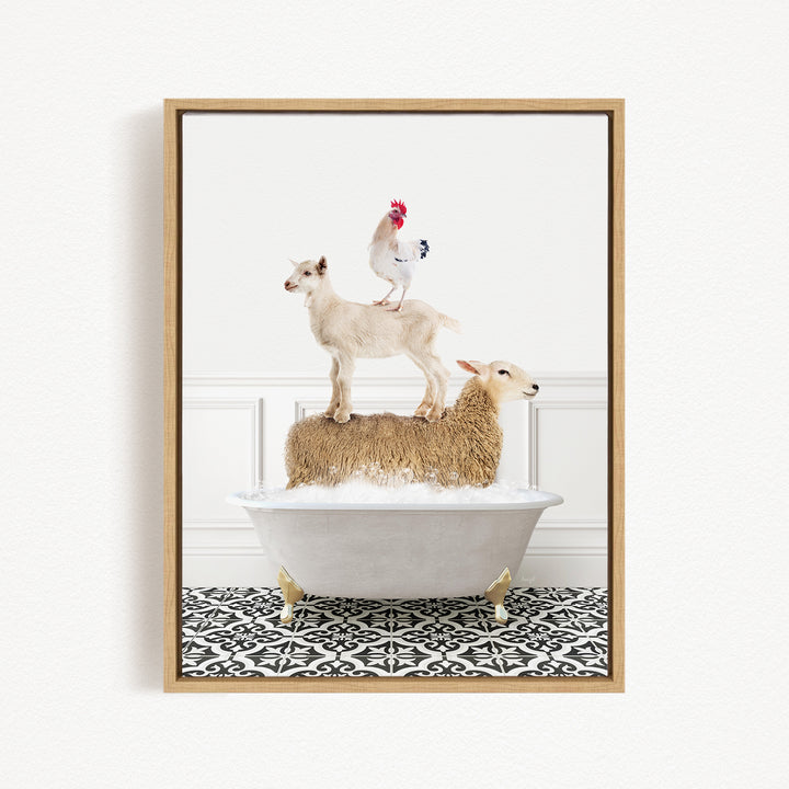 A framed image depicting a goat standing on top of a sheep in a bathtub, with a rooster perched on the sheep's back.