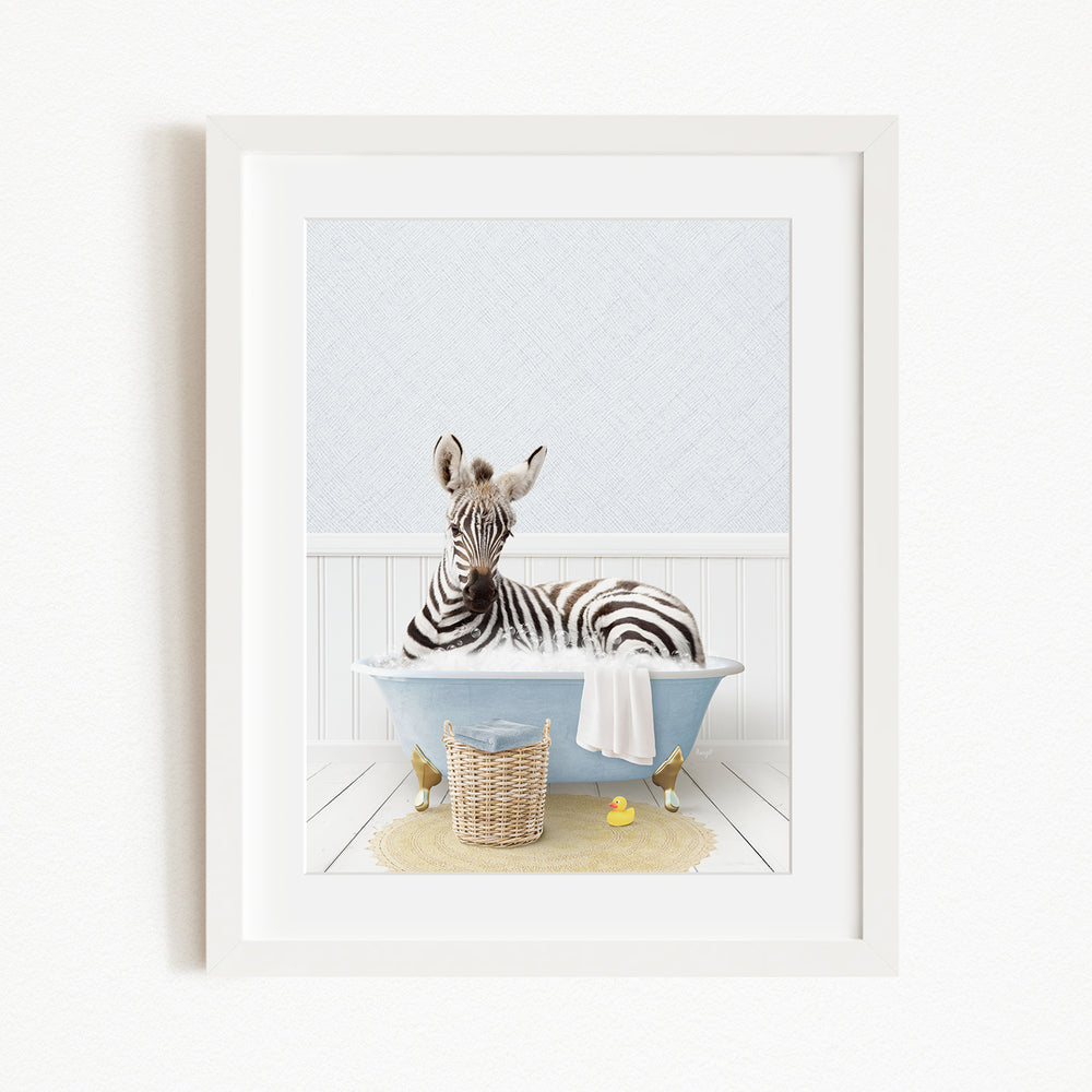 A zebra is sitting in a blue bathtub filled with water, surrounded by rubber ducks and a basket.