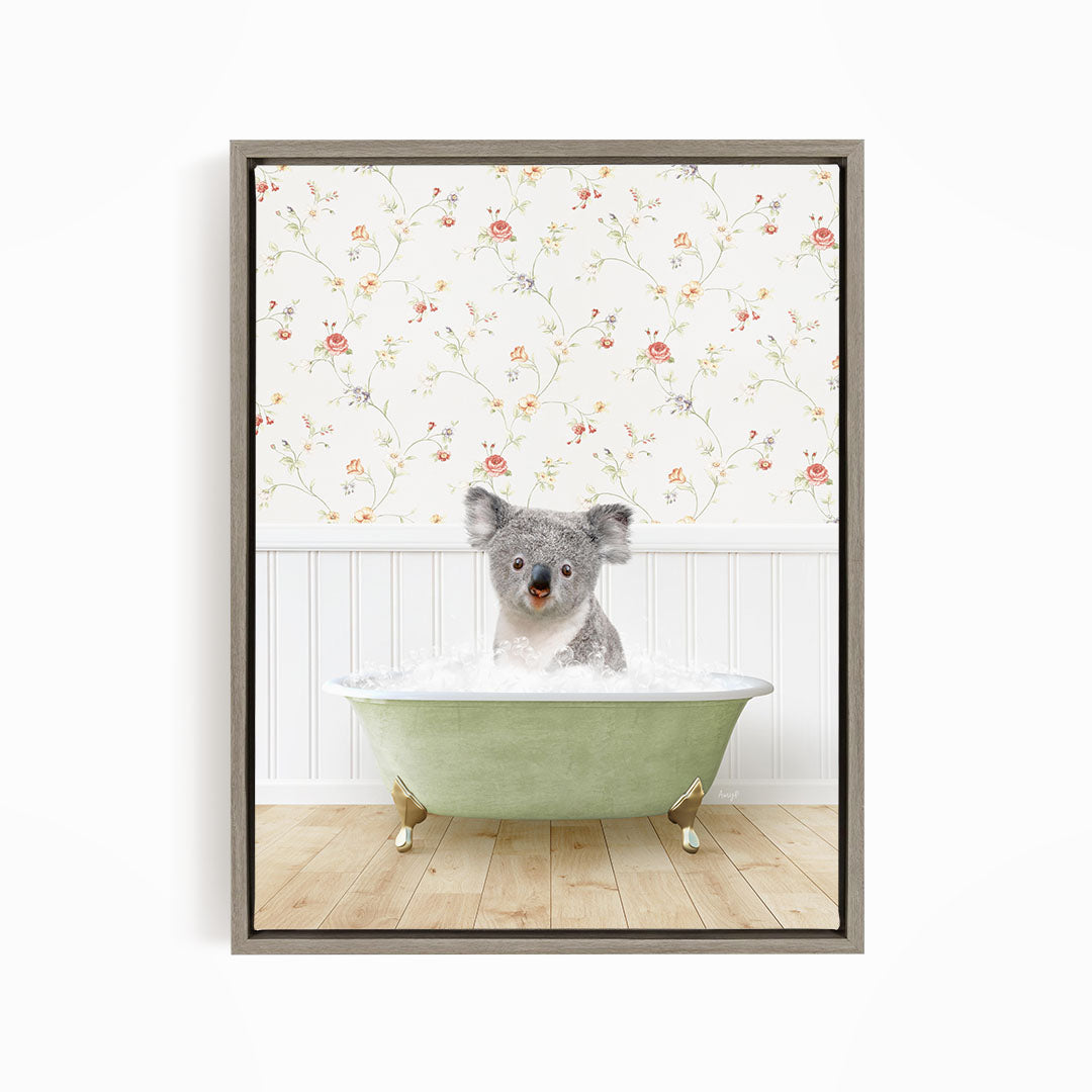 A koala bear sitting in a green bathtub filled with water, with a floral wallpaper in the background.