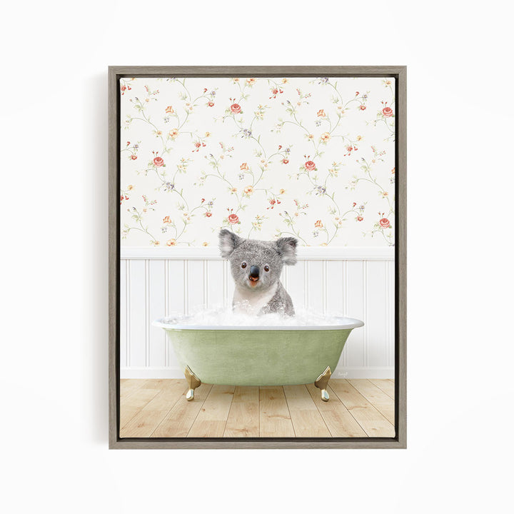 A koala bear sitting in a green bathtub filled with water, with a floral wallpaper in the background.