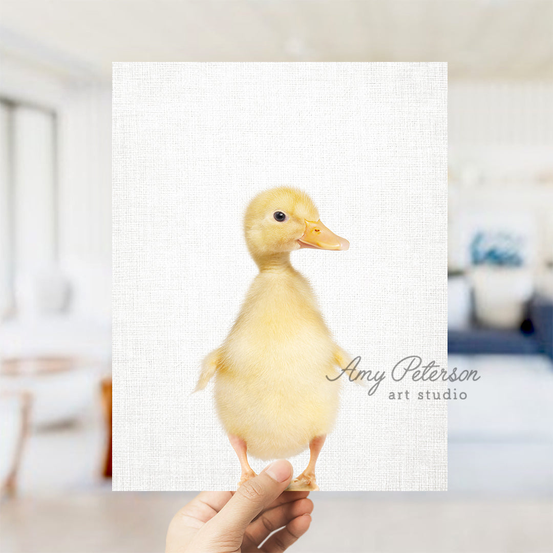 a hand holding up a card with a picture of a duck