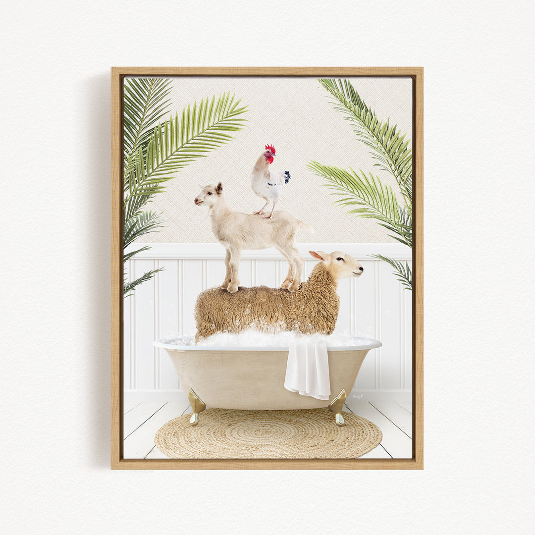 A framed image depicting a goat standing on a sheep's back while a rooster sits on top of the sheep, all in a bathtub surrounded by palm leaves.