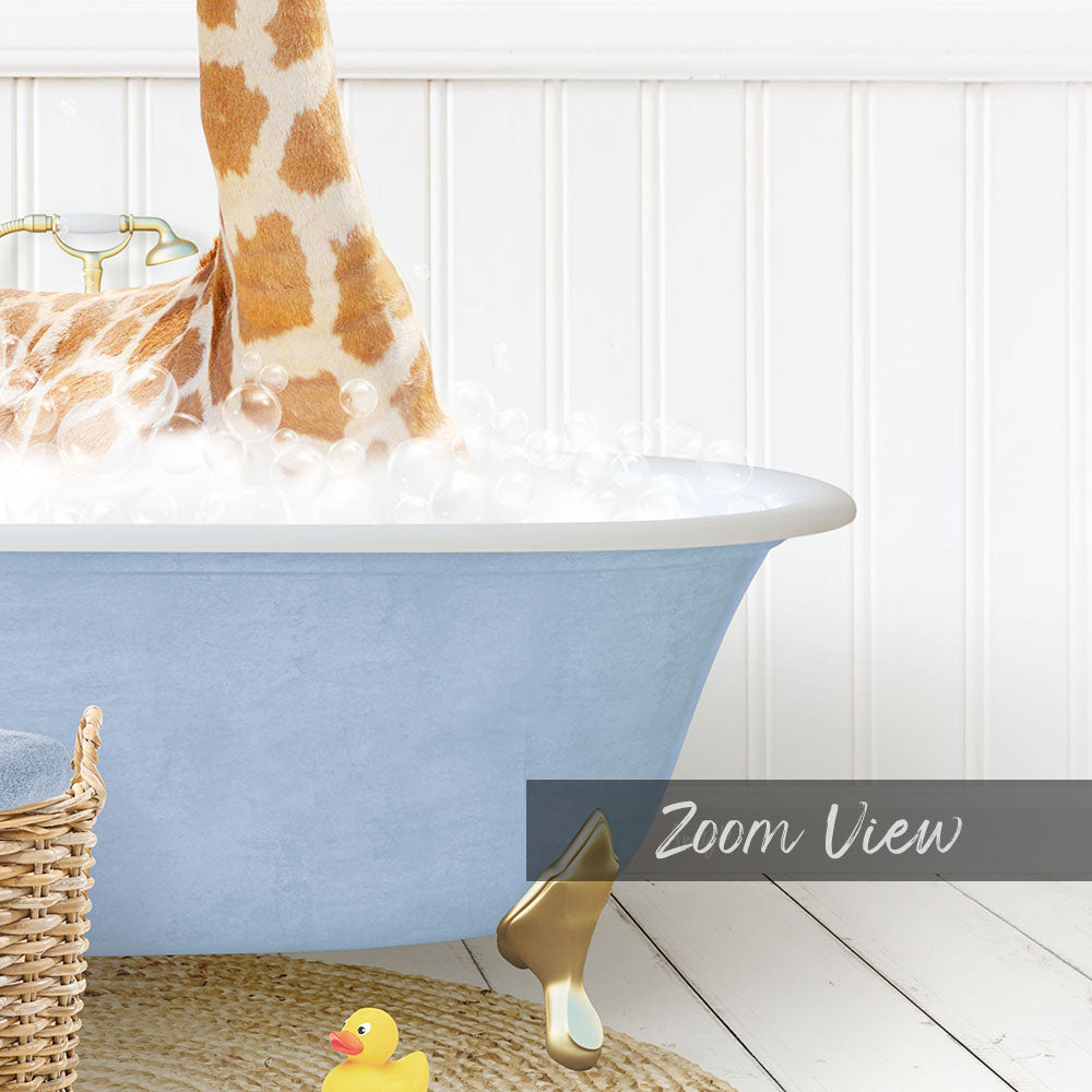 A giraffe standing in a blue bathtub filled with bubbles, with a yellow rubber duck nearby.
