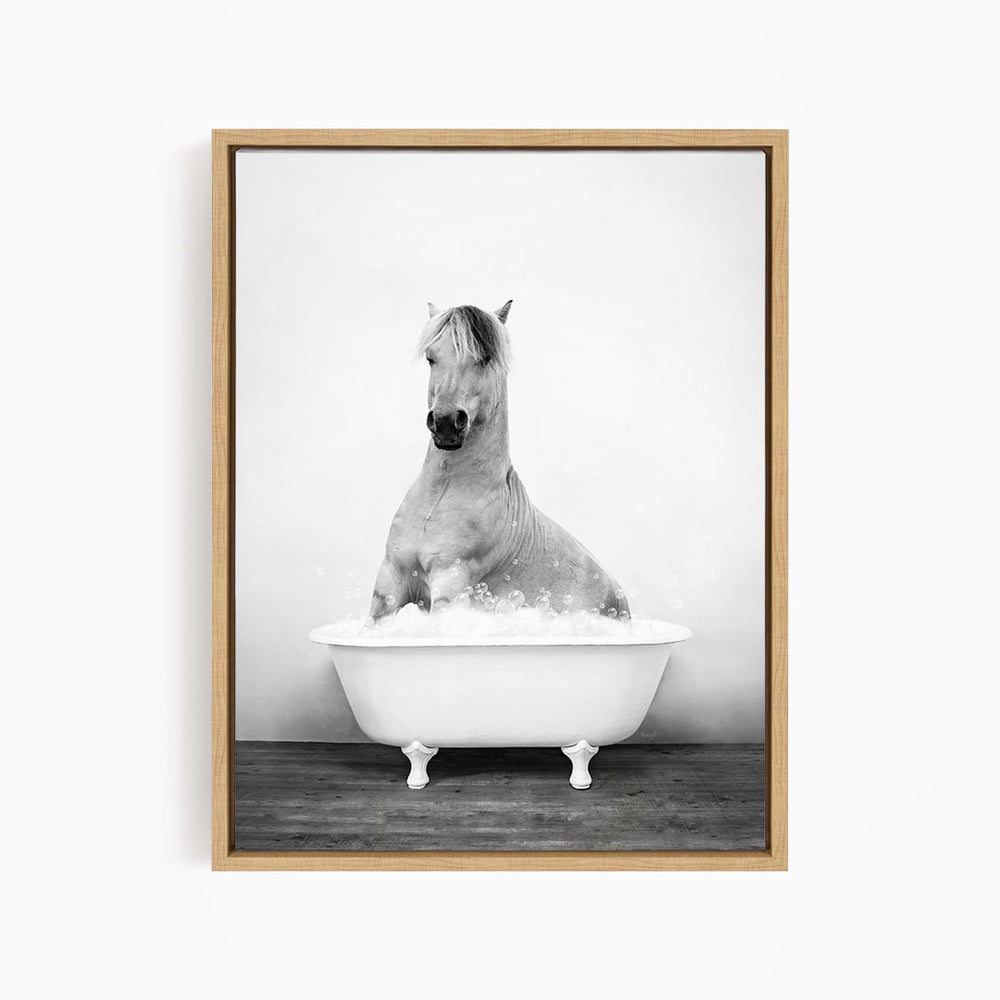 A horse sitting in a bathtub filled with water, appearing to enjoy the bath.