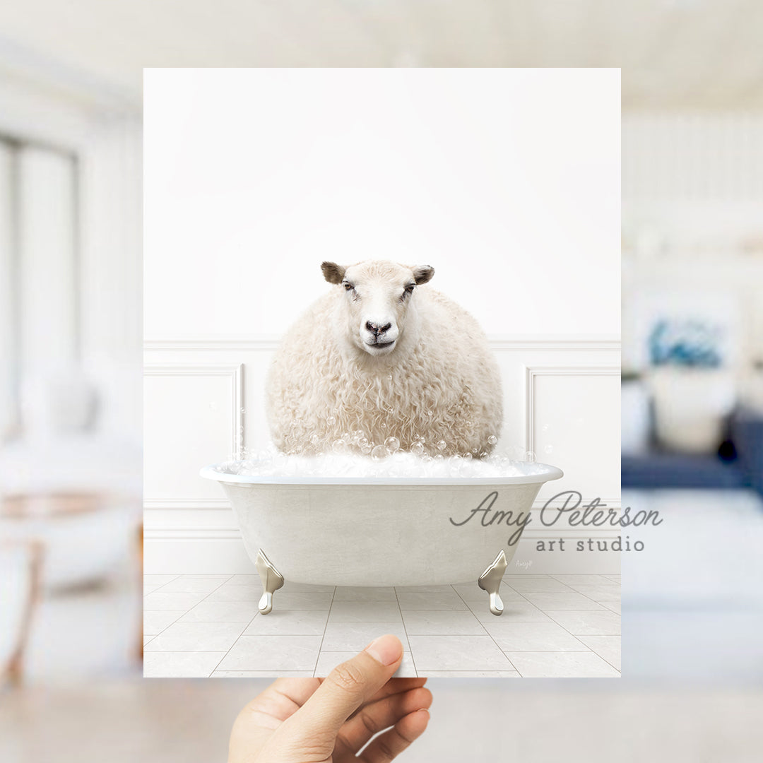 a hand holding a card with a sheep in a bathtub