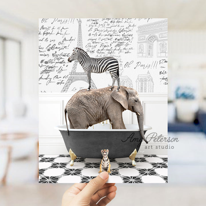 a person holding up a card with a picture of an elephant and a zebra