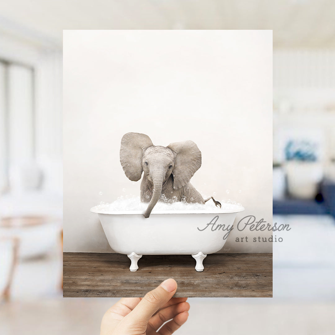 a person holding up a picture of an elephant in a bathtub