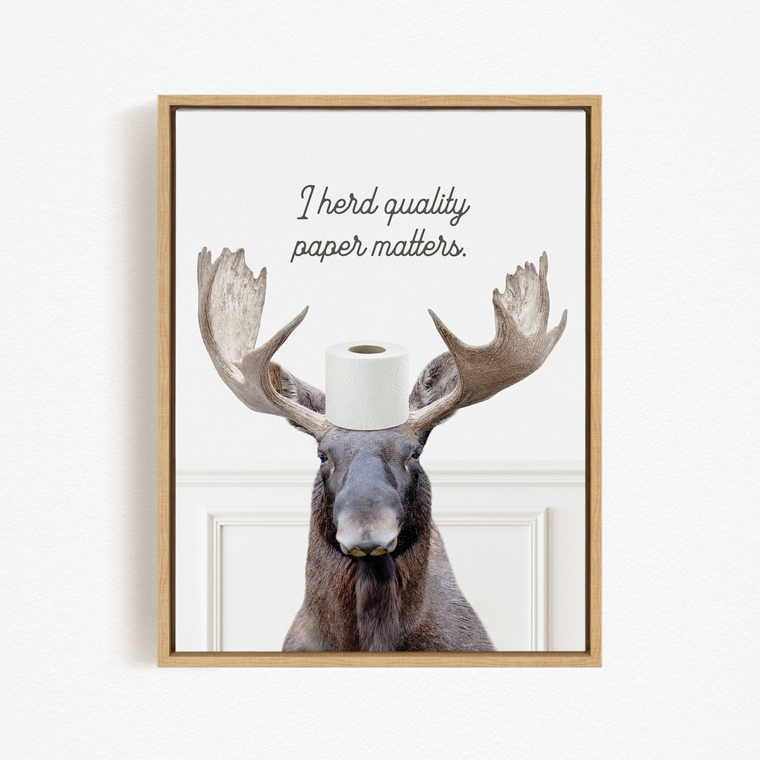 A moose with a roll of toilet paper on its head, accompanied by the text "I herd quality paper matters."
