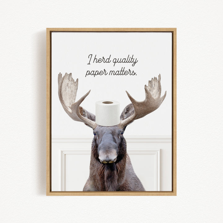 A moose with a roll of toilet paper on its head, accompanied by the text "I herd quality paper matters."