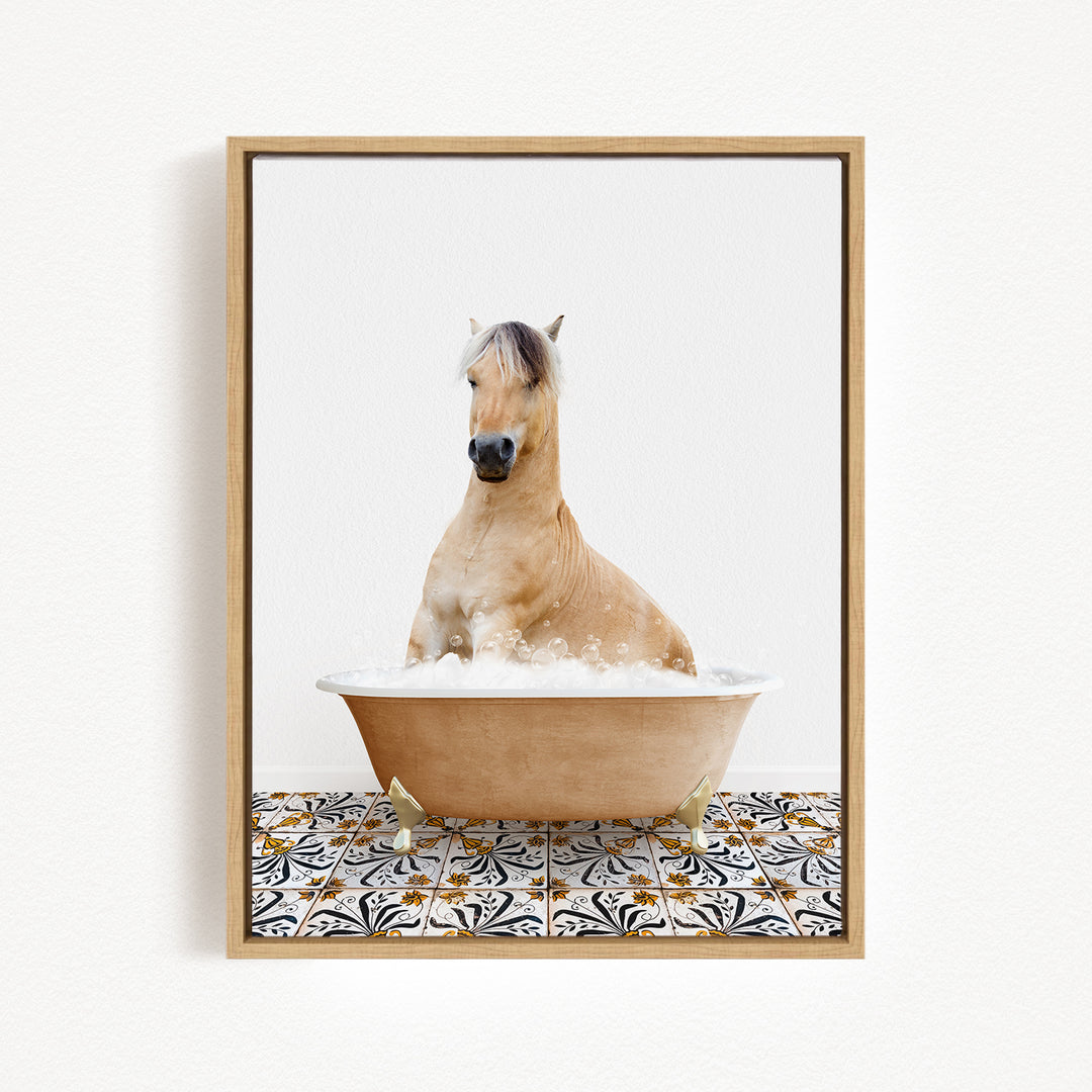 A light brown horse is sitting in a bathtub filled with bubbles, surrounded by a patterned tile floor.