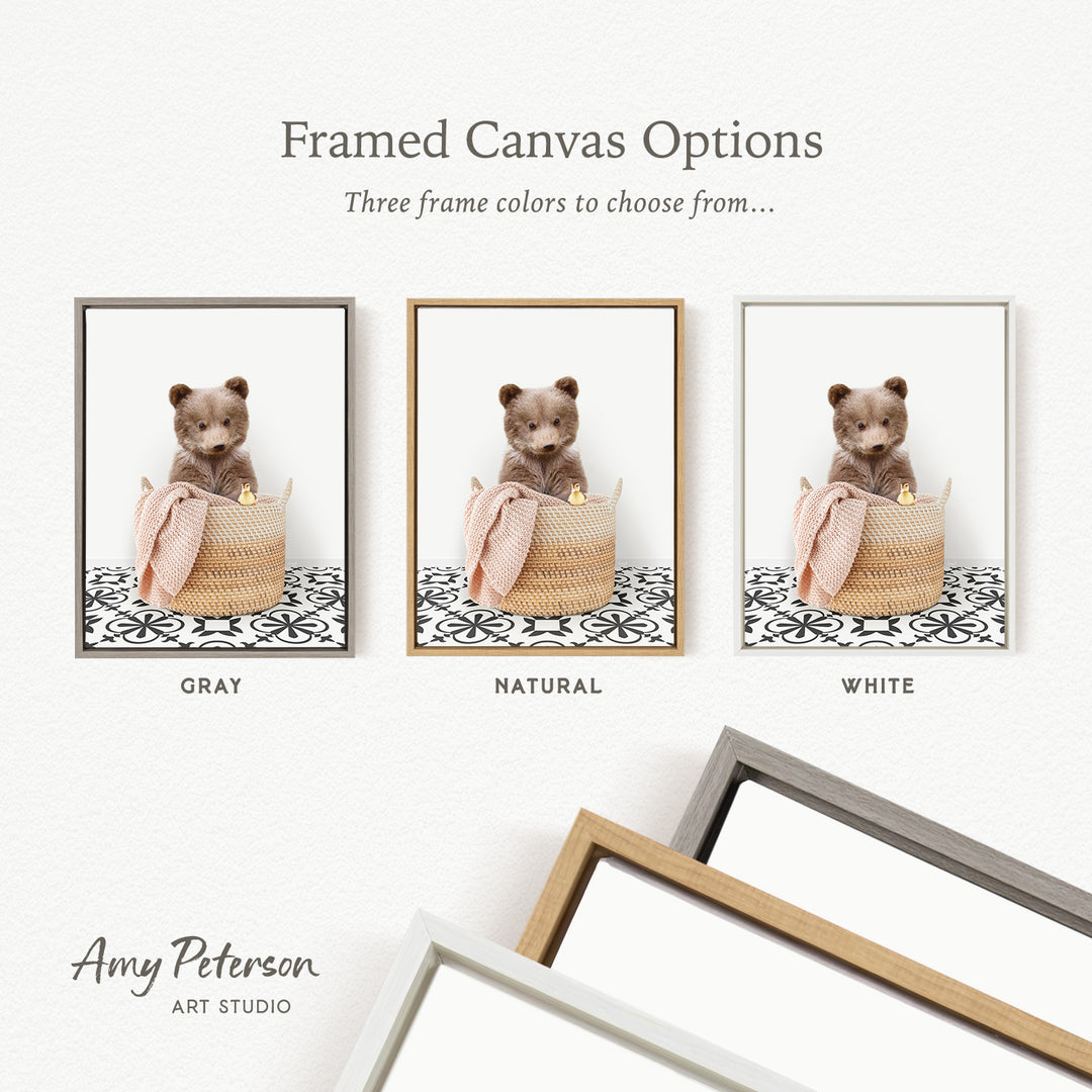 three framed canvas options, each featuring a brown teddy bear sitting in a basket. The options include a gray frame, a natural frame, and a white frame.