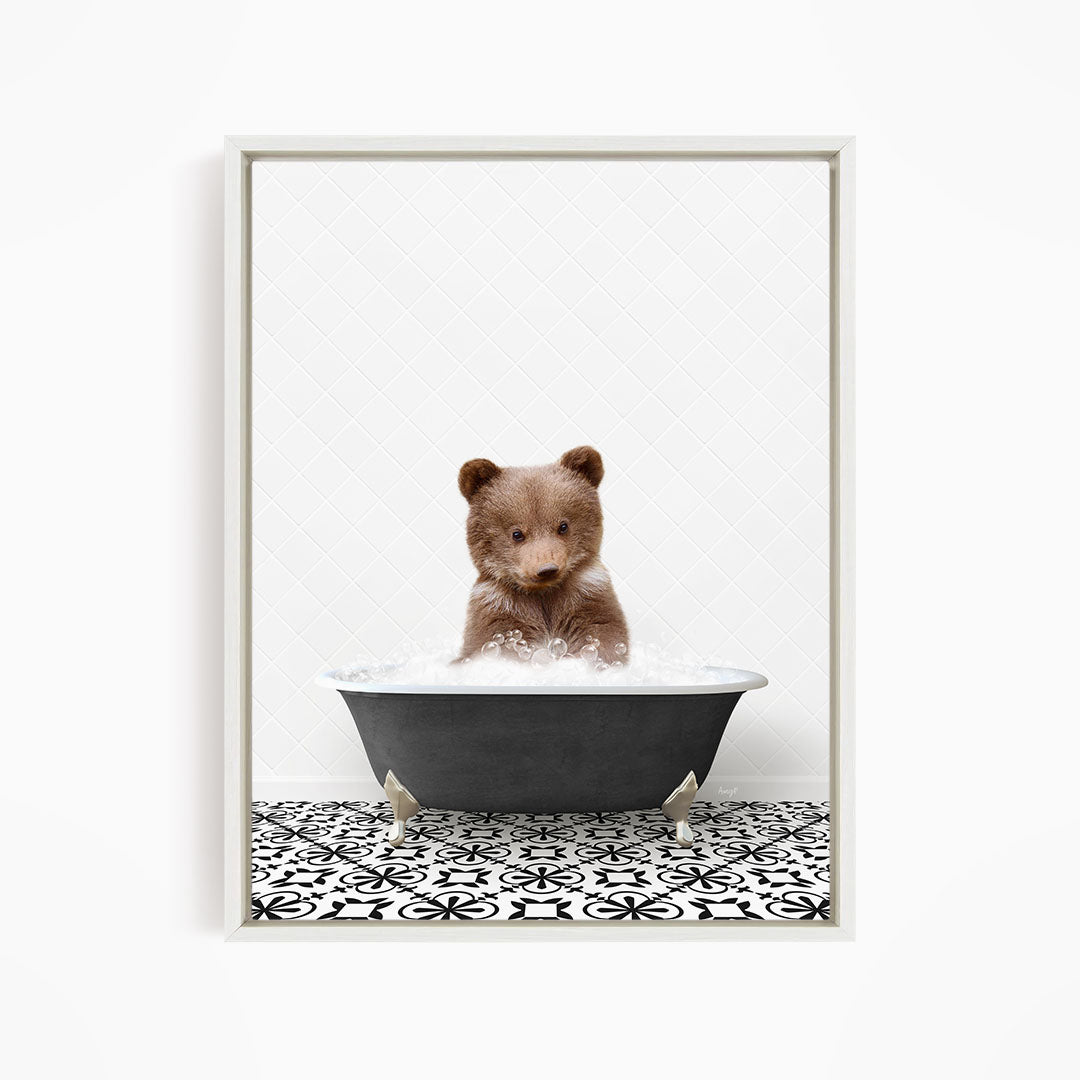 A cute brown bear sitting in a black bathtub filled with water, surrounded by a black and white patterned floor.
