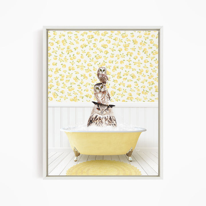 A framed image depicting three owls sitting in a yellow bathtub, with a yellow and white floral wallpaper in the background.