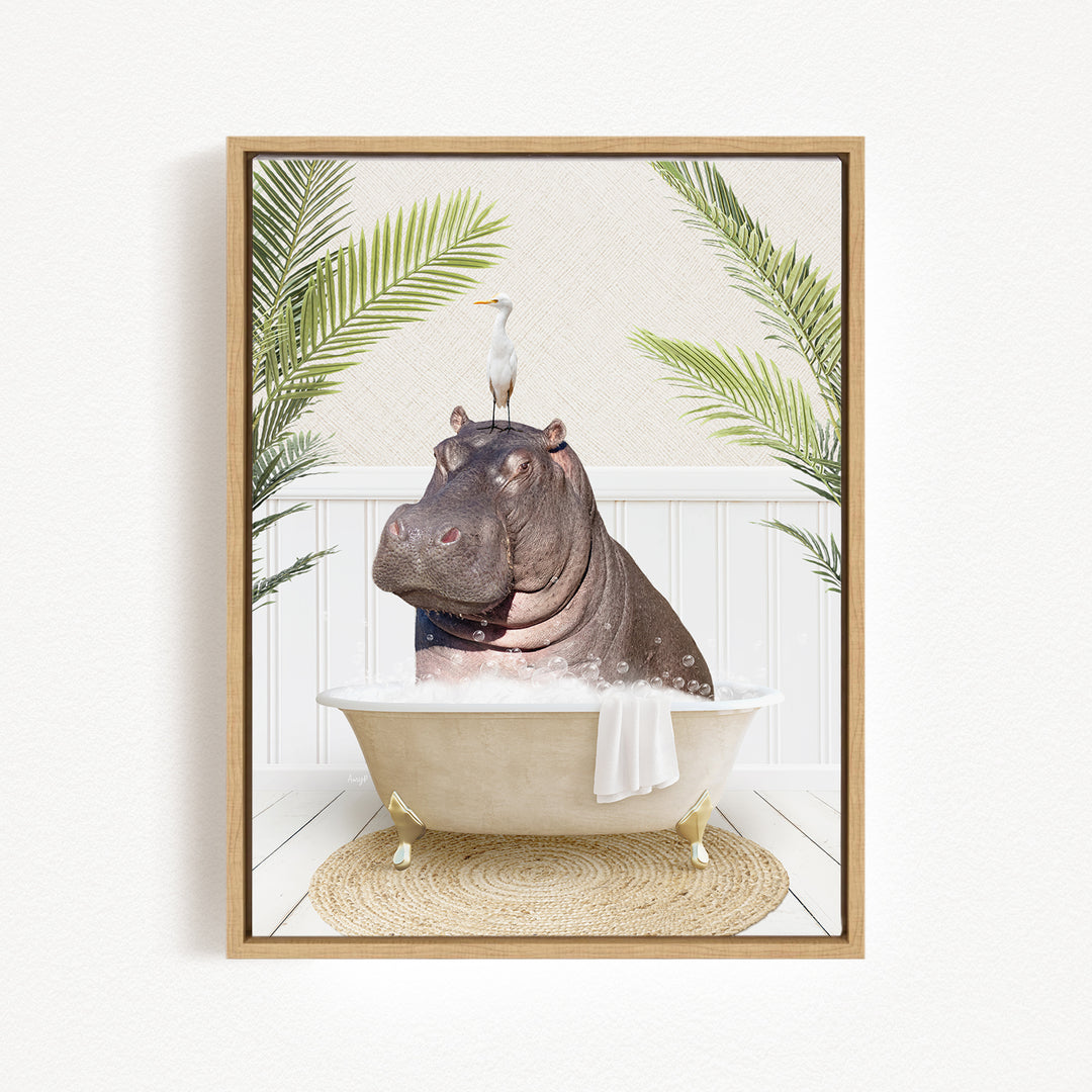 A framed image depicting a hippopotamus sitting in a bathtub, with a bird perched on its head.