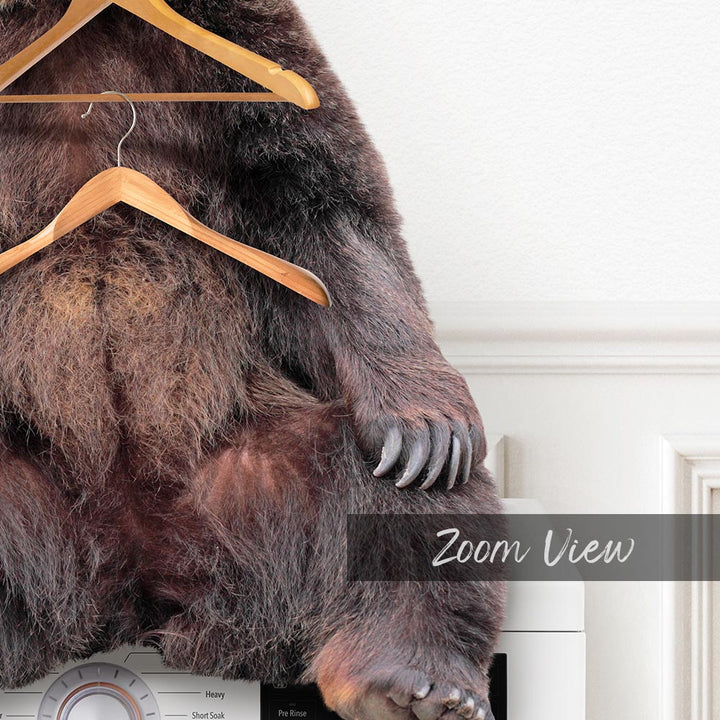 a brown bear sitting on top of a dryer