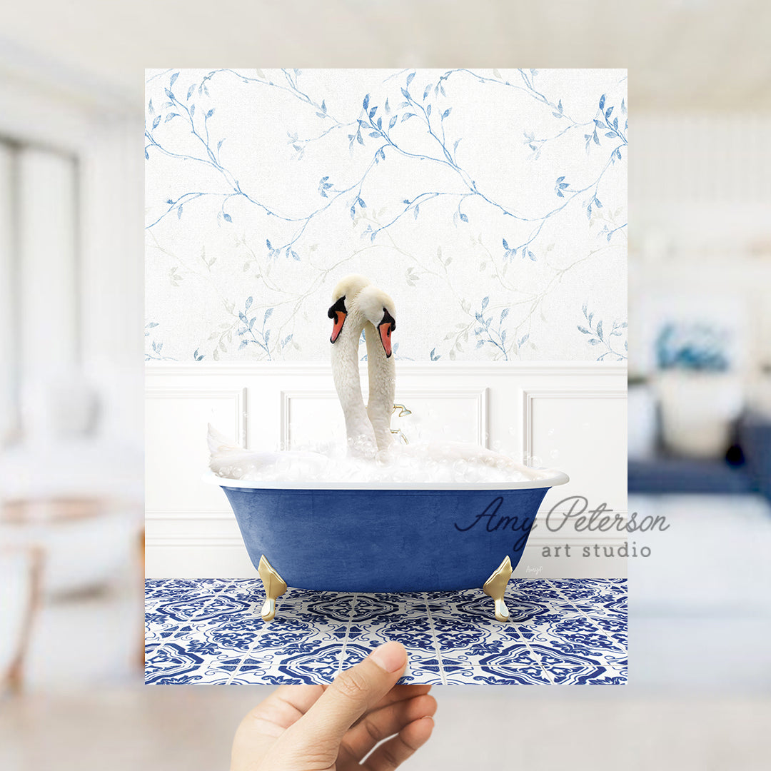 a person holding a card with a picture of two swans in a bathtub