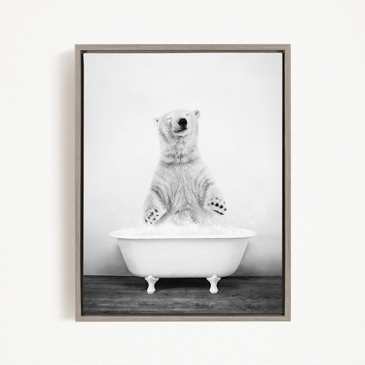 A polar bear standing in a white bathtub filled with water, appearing to be enjoying a bath.