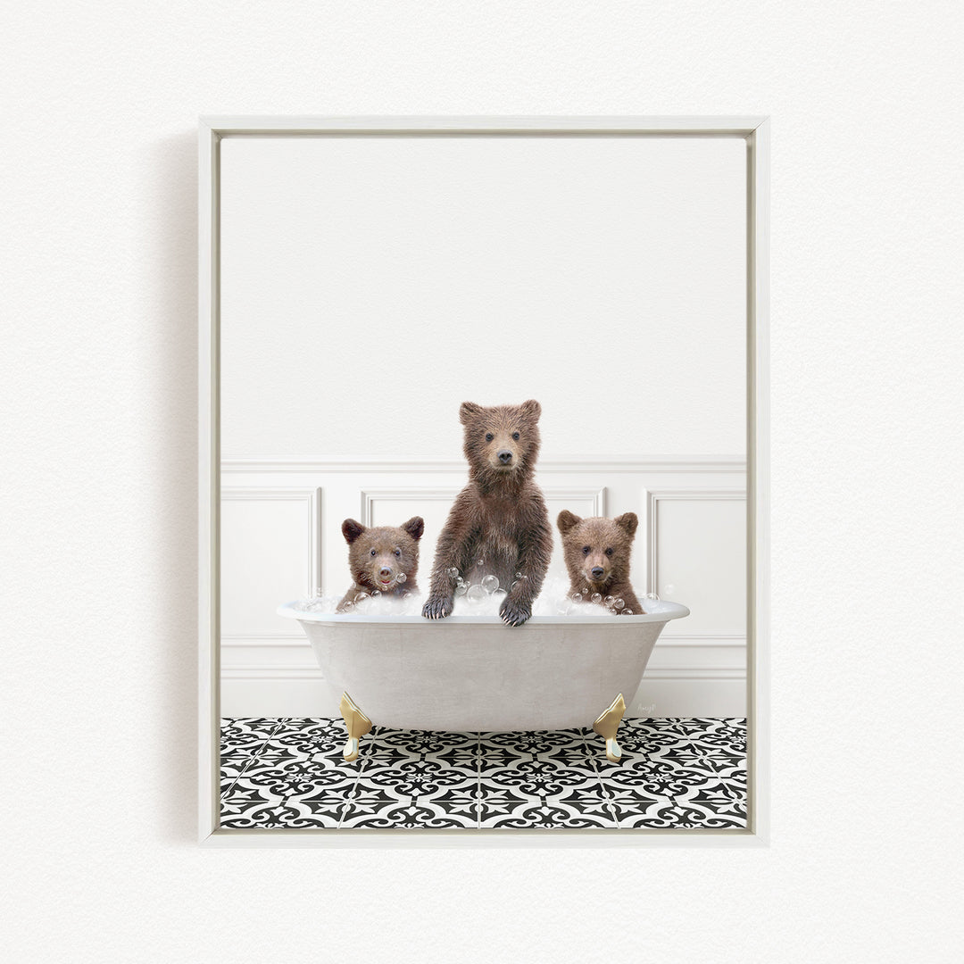 Three adorable brown bears sitting in a white bathtub, with one bear sitting at the center and the other two sitting on either side.
