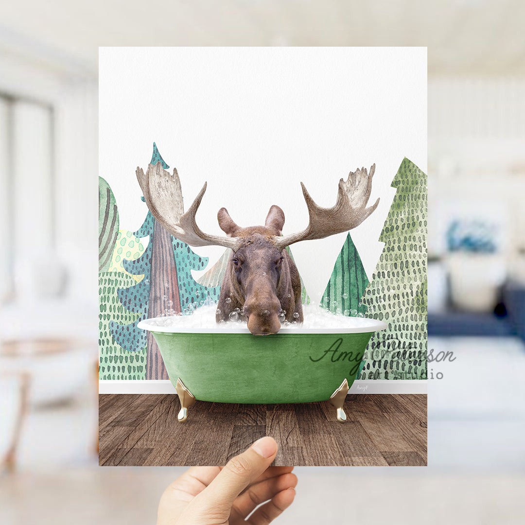 a hand holding up a card with a picture of a moose in a bathtub