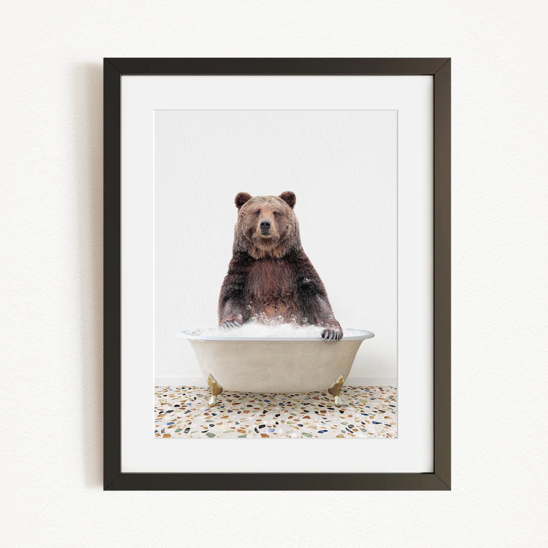 A brown bear sitting in a white bathtub filled with water, creating a whimsical and playful scene.