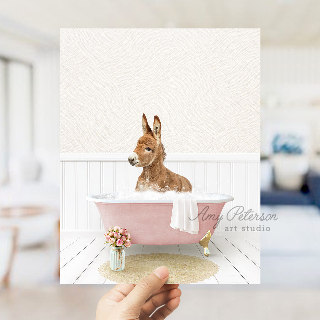 a hand holding a card with a dog in a bathtub