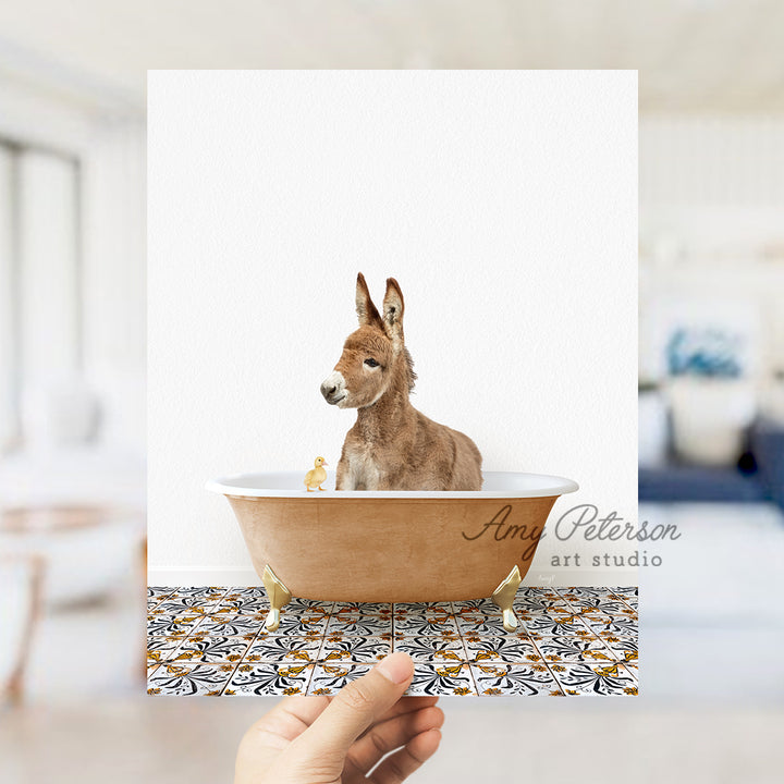 a person holding a card with a picture of a donkey in a bathtub