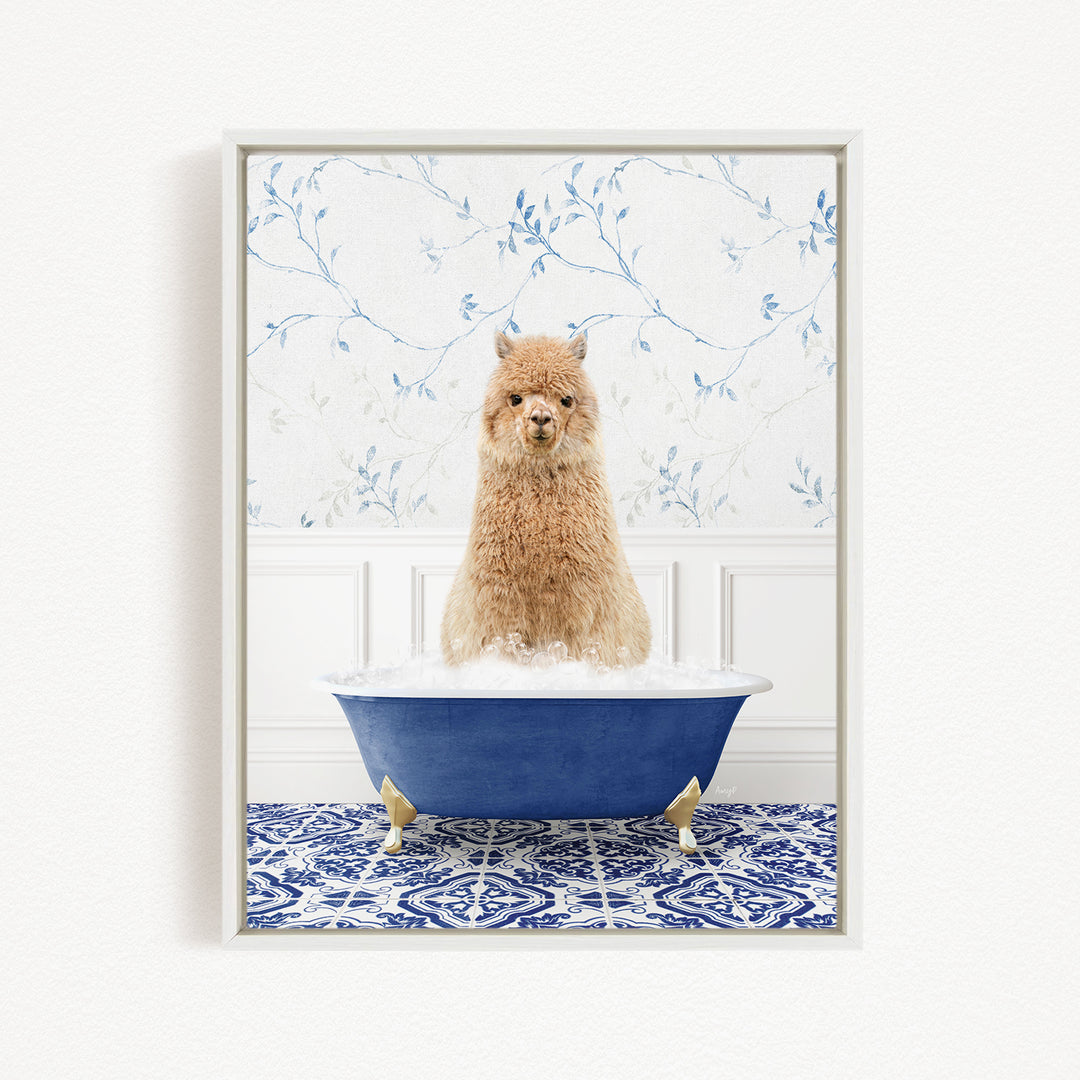 A fluffy brown alpaca sitting in a blue bathtub filled with bubbles, surrounded by a blue and white patterned rug.