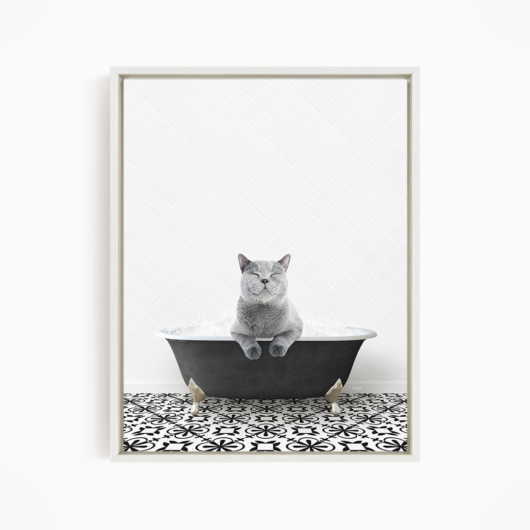 A gray cat sitting in a bathtub filled with bubbles, looking relaxed and content.