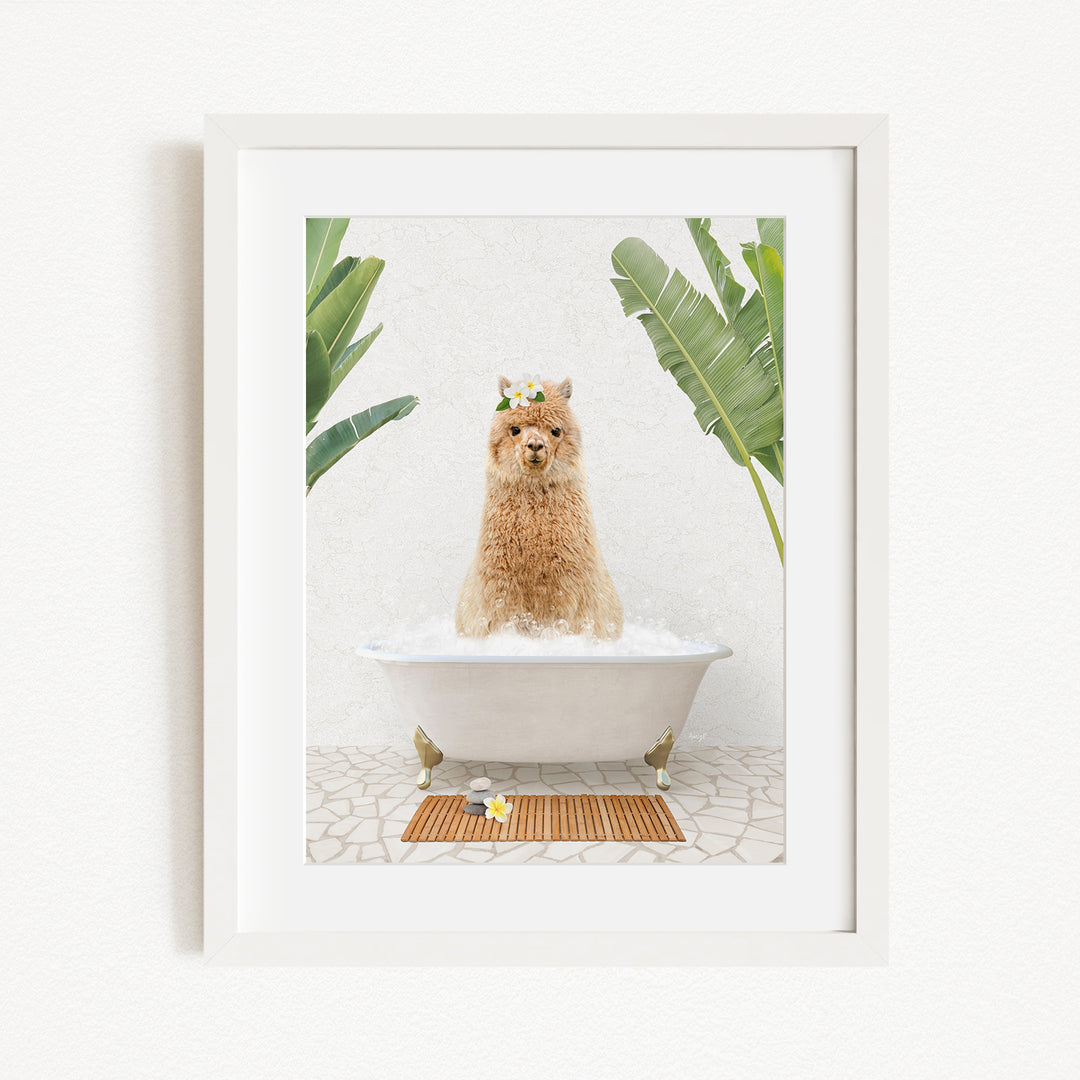A brown alpaca sitting in a white bathtub, surrounded by green plants and a wooden mat on the floor.