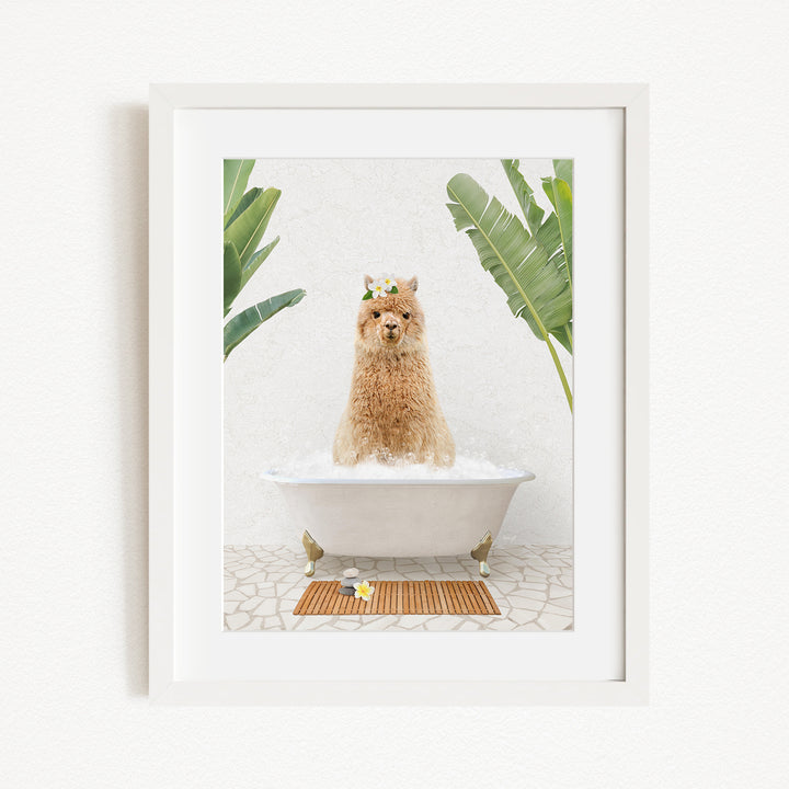 A brown alpaca sitting in a white bathtub, surrounded by green plants and a wooden mat on the floor.