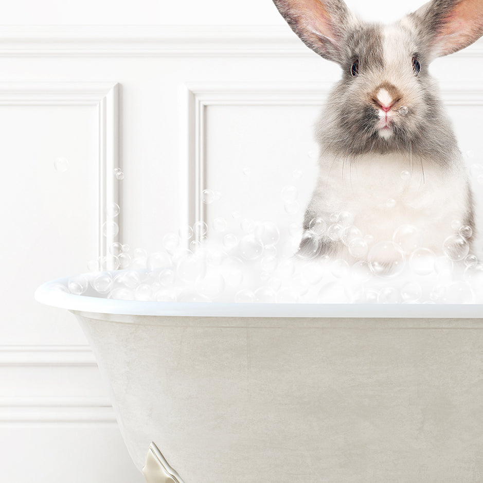 a rabbit sitting in a bathtub full of bubbles