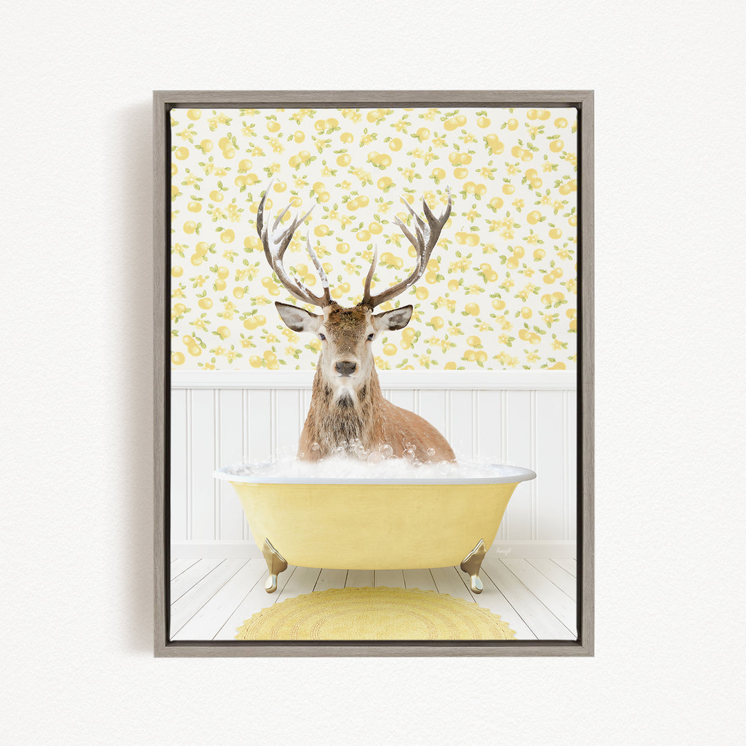 A deer with large antlers is sitting in a yellow bathtub, surrounded by a yellow and white patterned wallpaper.