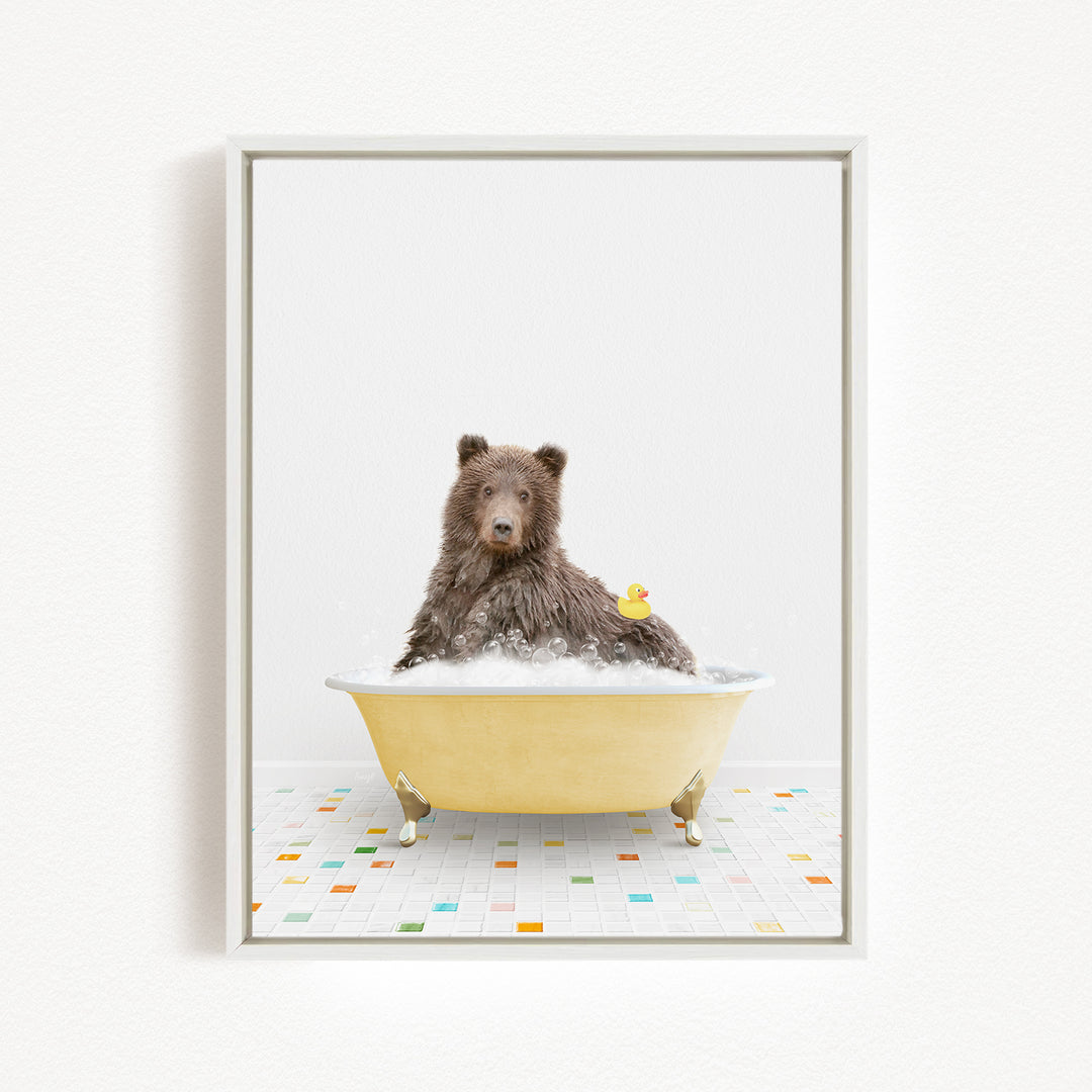 A brown bear sitting in a yellow bathtub, surrounded by colorful tiles on the floor.