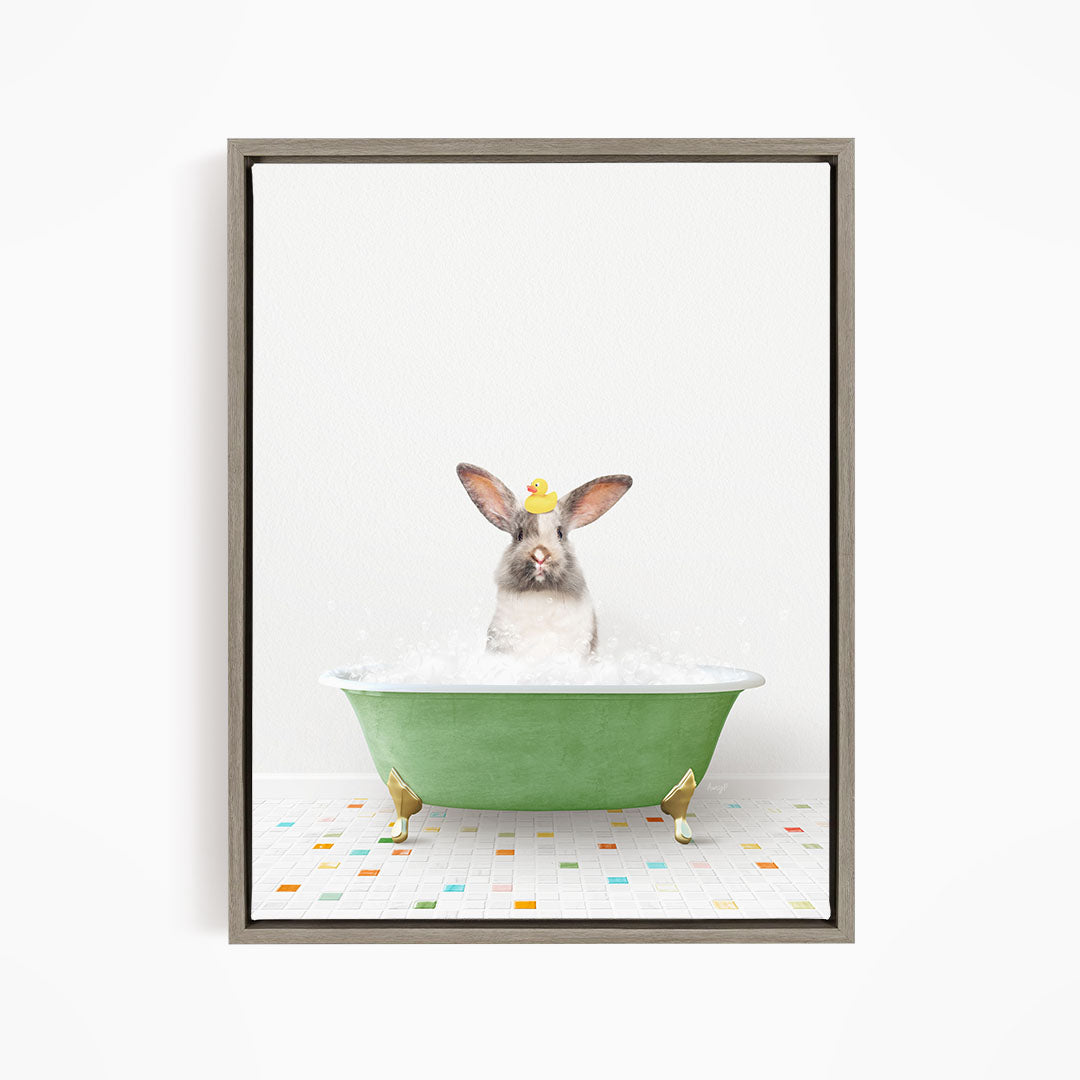 A cute rabbit sitting in a green bathtub filled with bubbles, with a yellow rubber duck floating on the water.