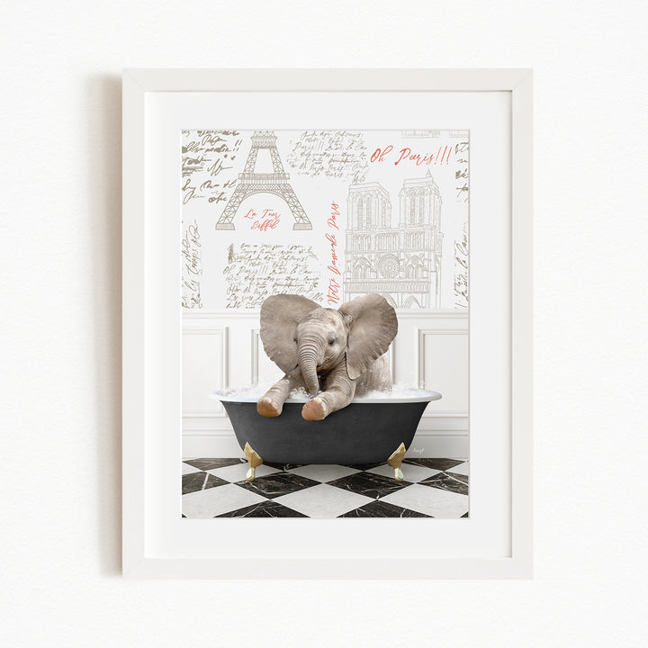 A framed image depicting a baby elephant sitting in a bathtub, with a Paris-themed background featuring the Eiffel Tower and other Parisian landmarks.