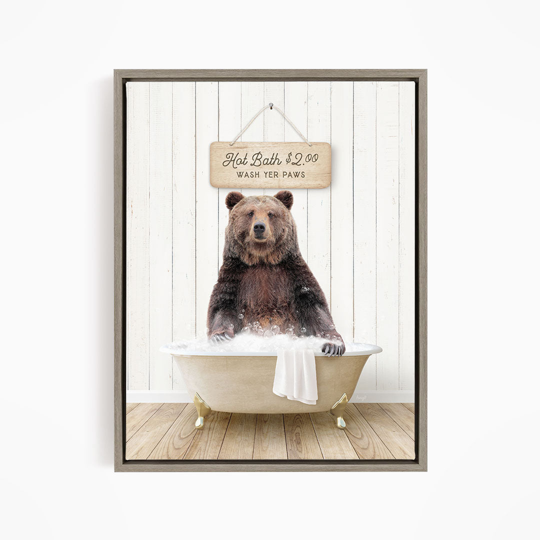A brown bear sitting in a bathtub, with a sign above it that says "Hot Bath $2.00 Wash Your Paws".