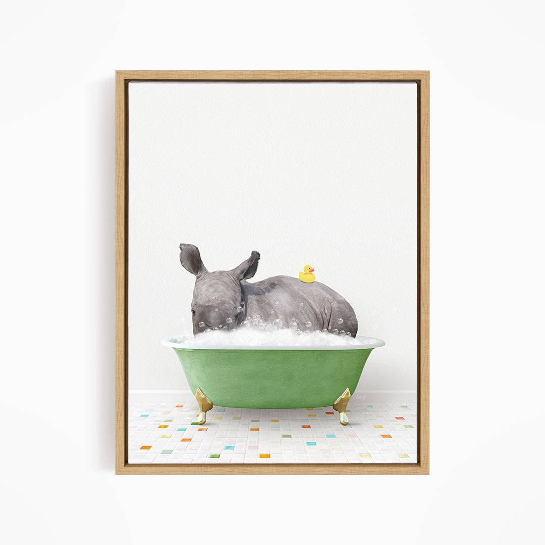 A rhinoceros is sitting in a green bathtub filled with bubbles, with a yellow rubber duck floating on its back.