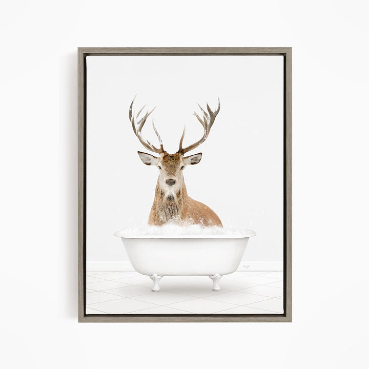 A deer with large antlers is sitting in a white bathtub filled with water, creating a whimsical and unexpected scene.